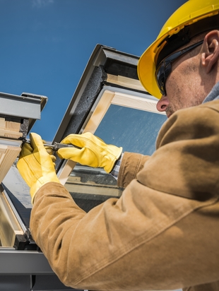 Worker performing maintenance on hopper window